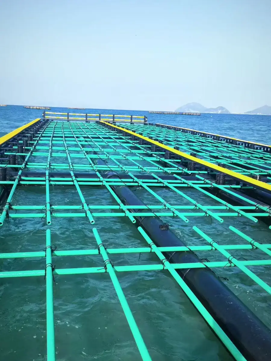 User-provided marine application photo showing green FRP tubular profiles assembled on an aquaculture platform